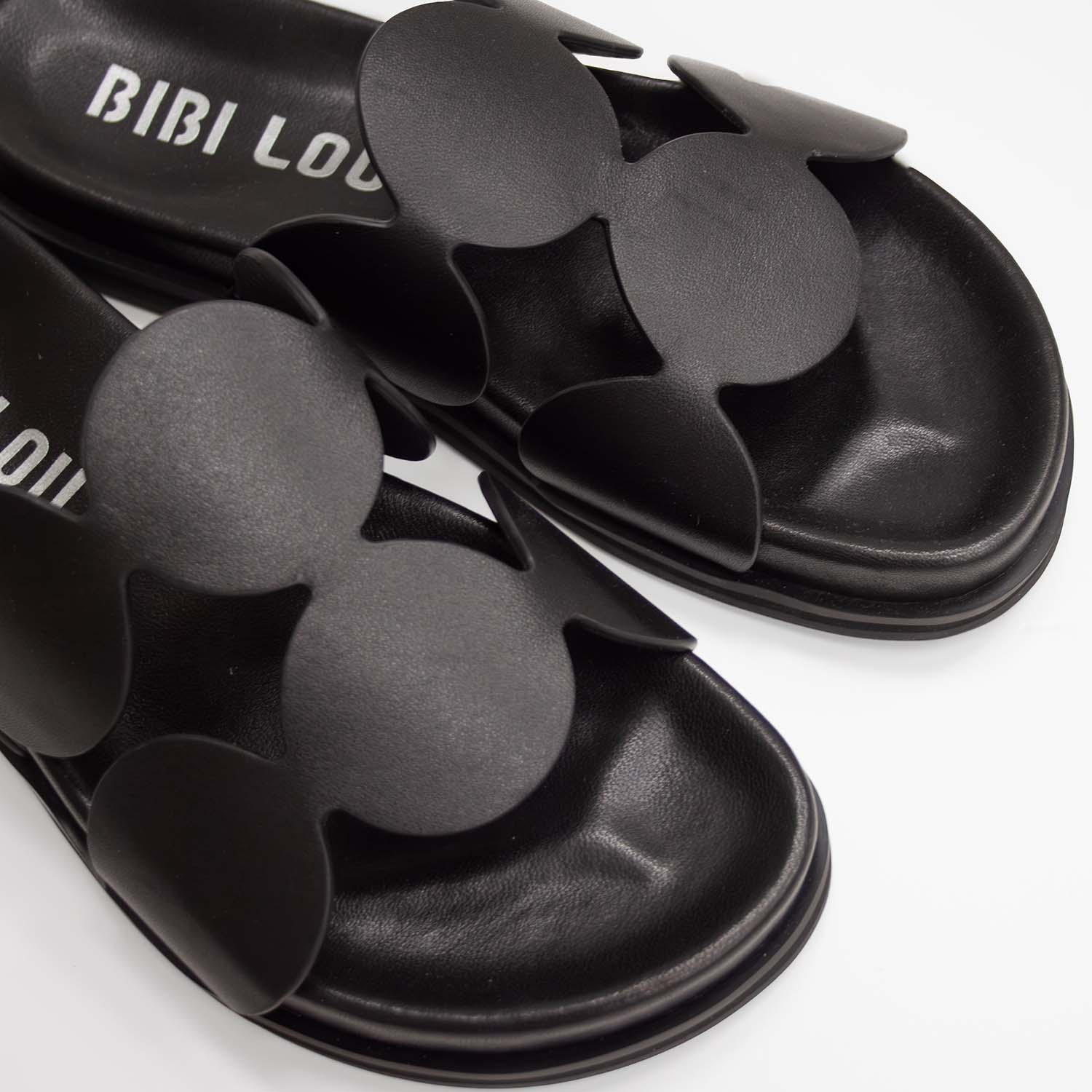 Skórzane klapki hiszpańskiej marki Bibi Lou – czarne, designerskie, ze skóry naturalnej, zbliżenie na stylowe wcięcia geometryczne.