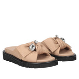 Klapki Tosca Blu – beżowe, skórzane, na platformie, pokazane pod kątem, z widoczną strukturą skóry i dekoracyjnym wykończeniem.