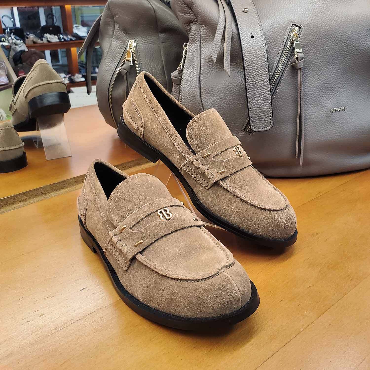 Loafersy hiszpańśkiej marki Bibi Lou – taupe, skórzane, zamszowe - widok z torebką.