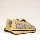 Sneakersy Tuffoni – żółte, ażurowe, skórzane, zdjęcie pokazujące oba buty z tyłu, z widoczną fakturą skóry i detalami podeszwy.