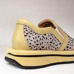 Zbliżenie na skórzane sneakersy Tuffoni – żółte, ażurowe, skórzane, widok z tyłu i z boku, eksponujący kontrastowe wykończenia i miękką linię zapiętka.